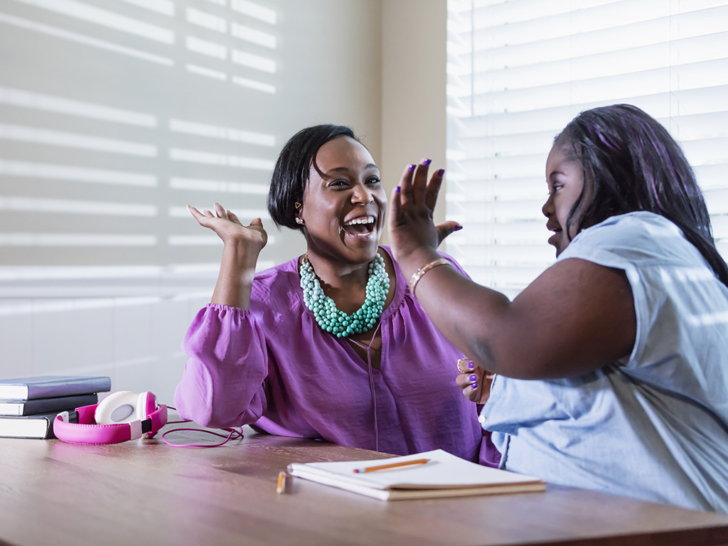 image of mother and daughter high-fiving